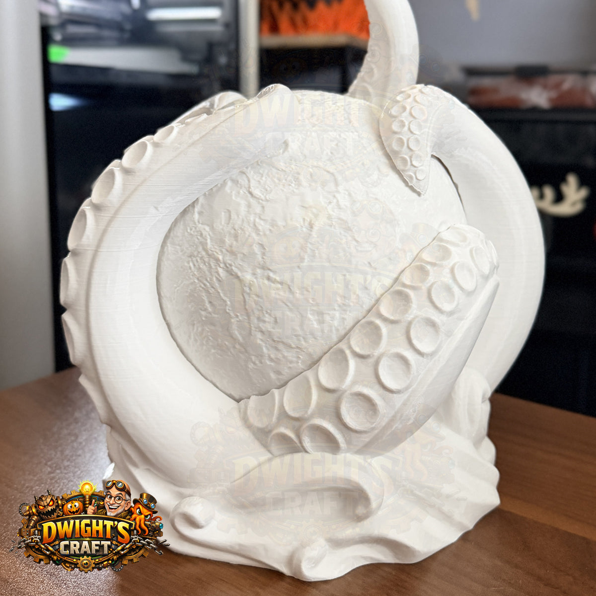 A white 3D-printed collectible figurine of a giant octopus tentacle wrapping around a spherical creature, displayed on a wooden table with a 'Dwight's Craft' logo overlay in the bottom-left corner.