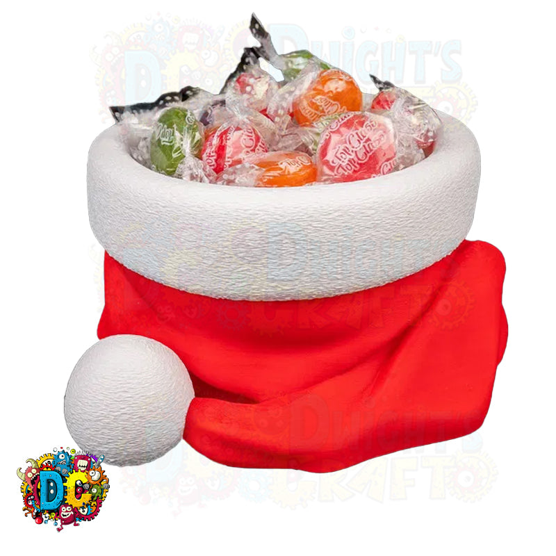 Red and white Santa hat filled with colorful candies on a white background