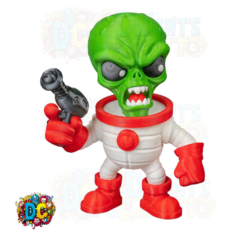 Toy figure of a green alien in a white suit with red boots on a wooden surface, next to a plant and globe.