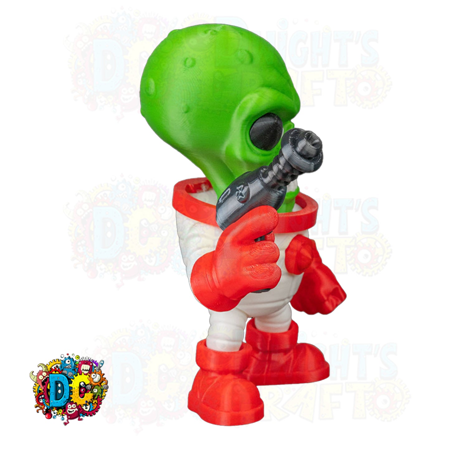 Toy figure of a green alien with red gloves and boots, holding a toy laser, on a white background with DC logo.