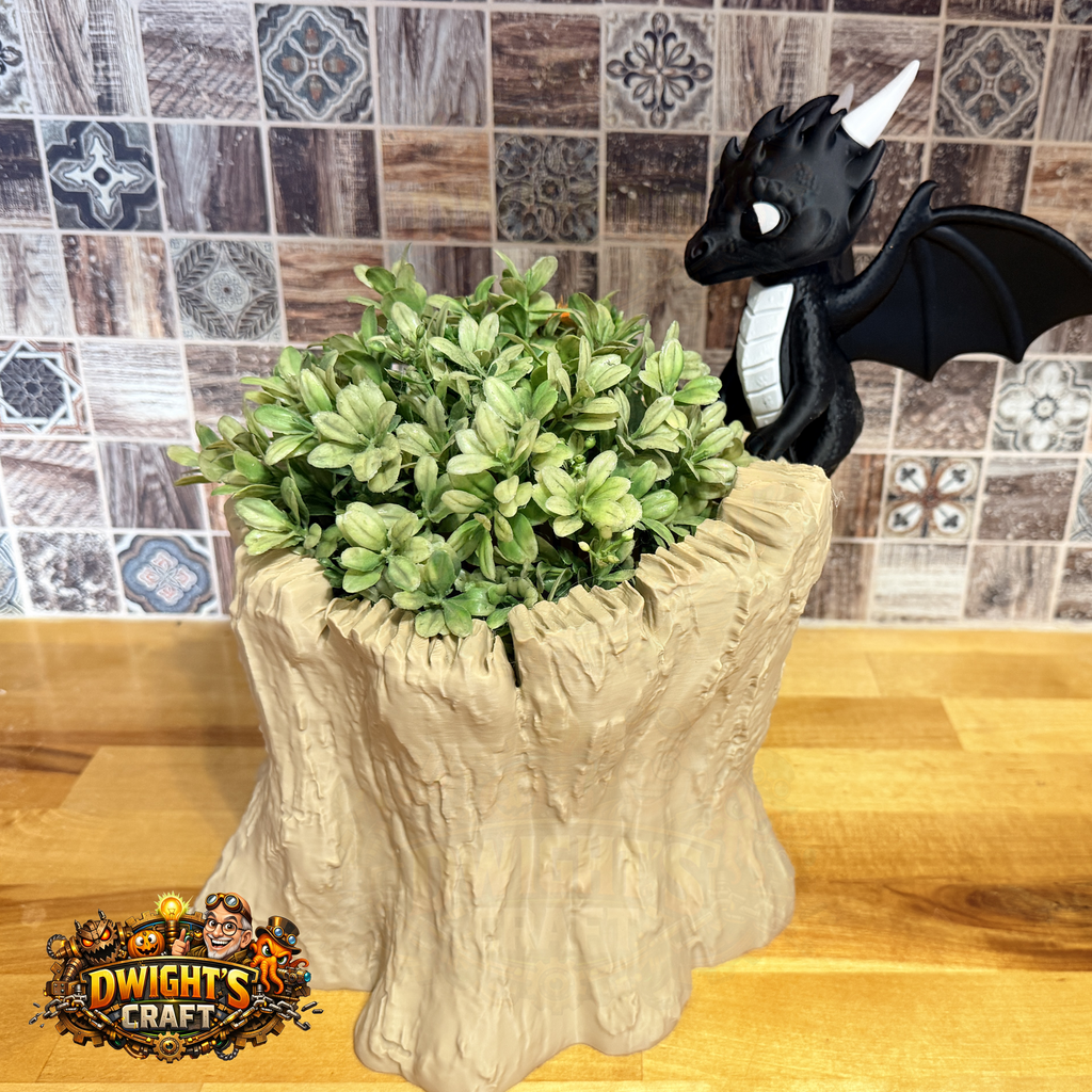 A decorative planter shaped like a tree stump with green leafy foliage on top and a black dragon figurine perched on the right side. The planter sits on a wooden surface in front of a tiled backsplash, with a 'Dwight's Craft' logo in the bottom-left corner.
