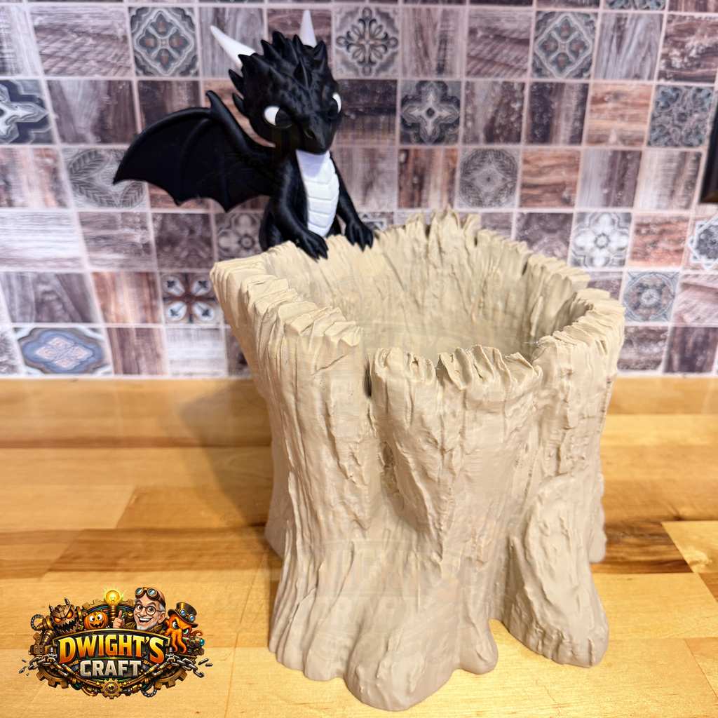 A black dragon figurine with white horns perched on top of a beige tree-stump-style planter, set on a wooden surface against a tiled wall. A 'Dwight's Craft' logo is visible in the bottom-left corner.