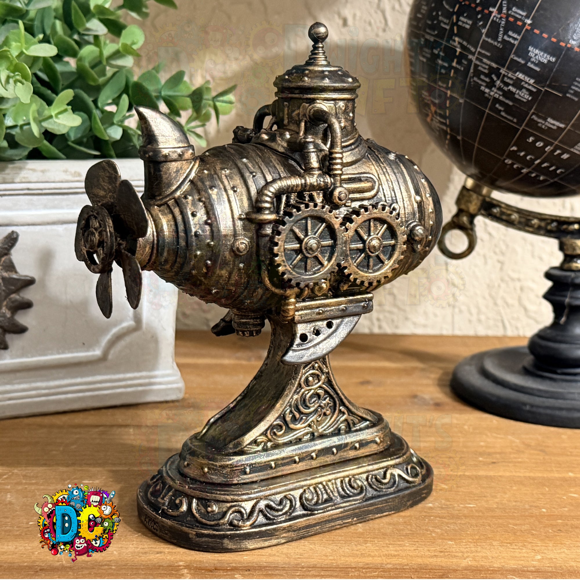 Decorative steampunk-style object on a wooden surface with a plant and globe in the background.
