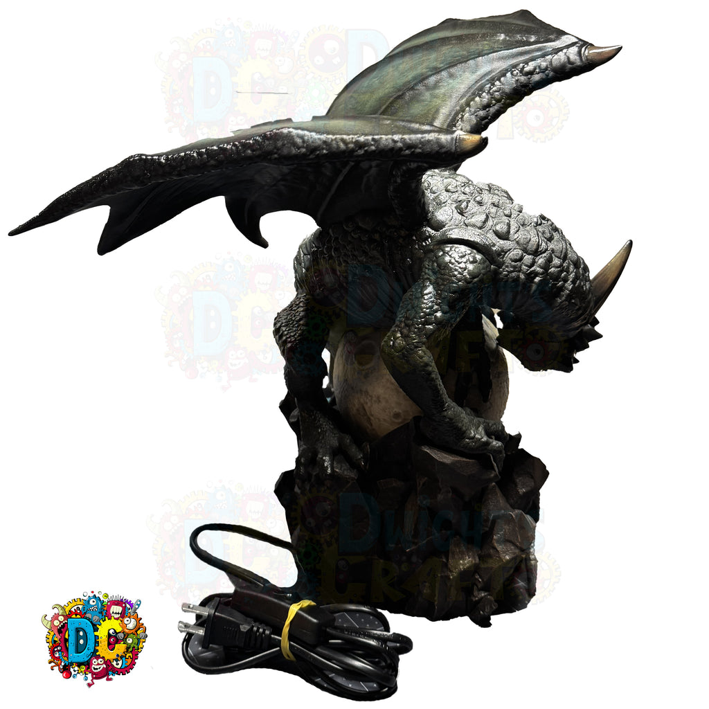 Dragon-shaped water fountain with power cord on a white background
