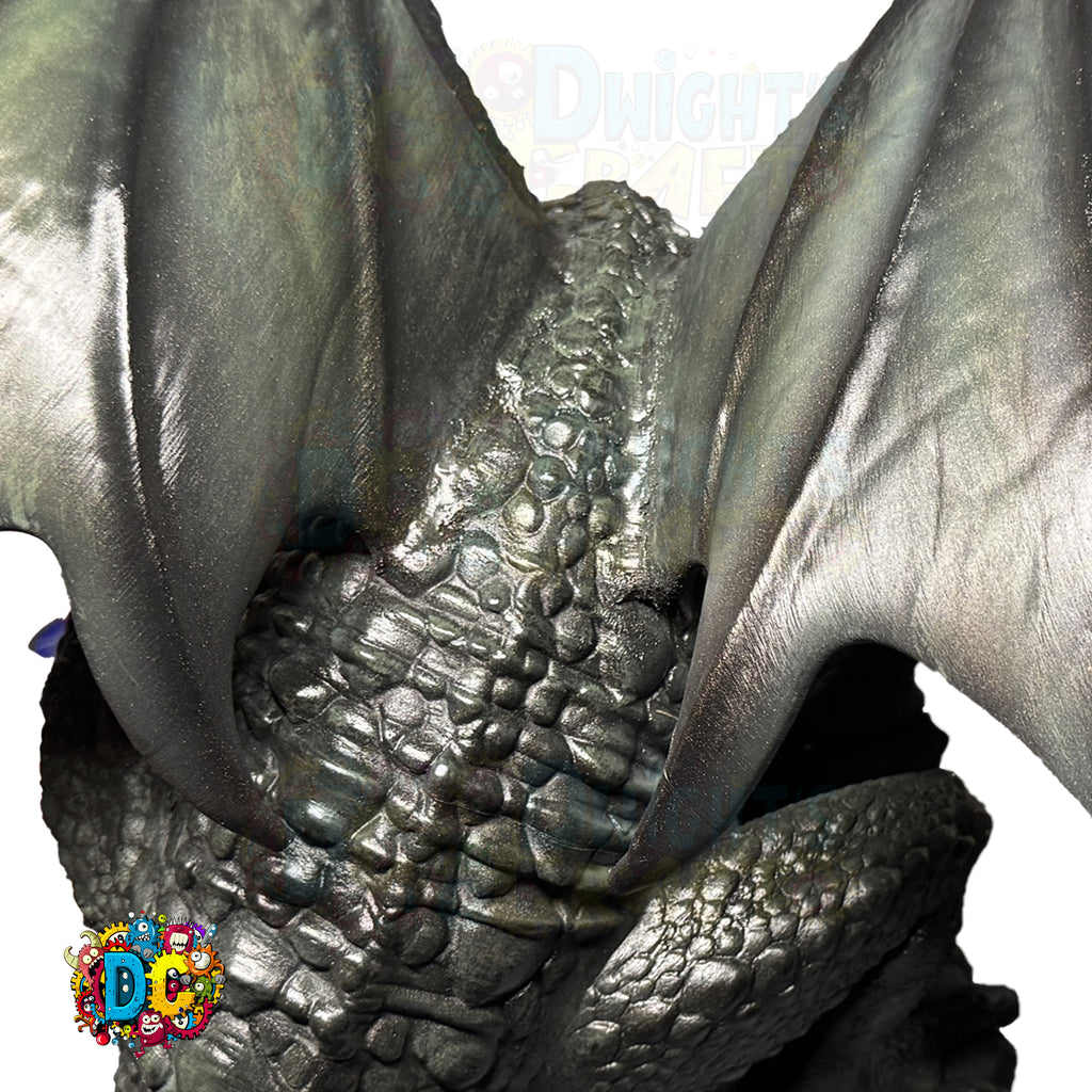 Close-up of a dragon's wing and body with a colorful logo in the corner.