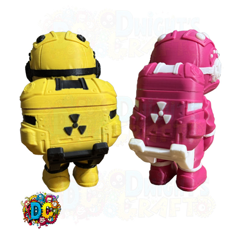 Two toy figures, one yellow and one pink, with radiation symbols on a white background.