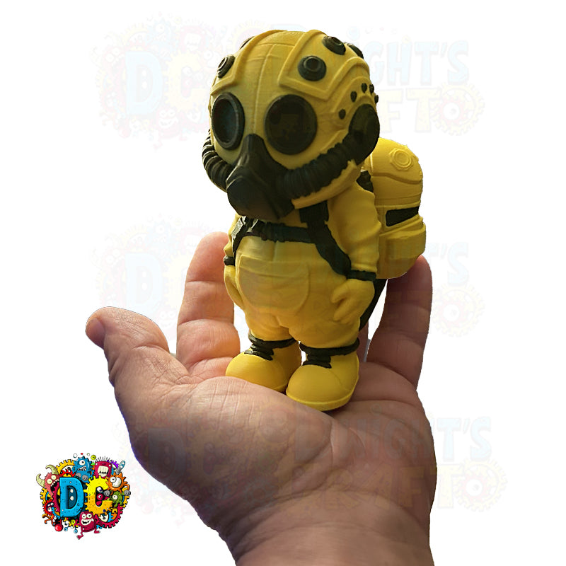 Yellow and black toy figure held in a hand against a white background