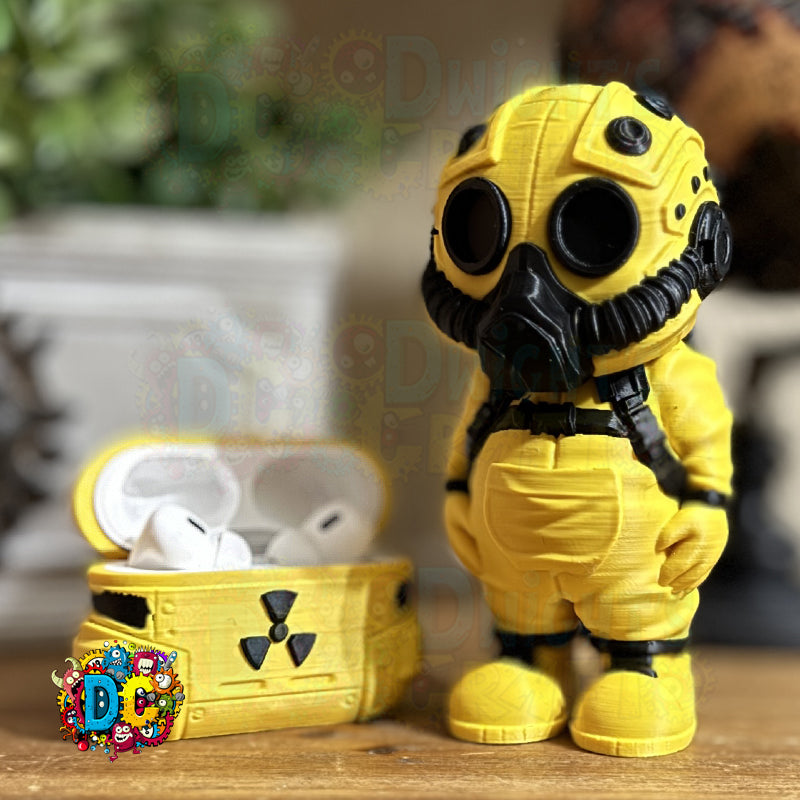 Yellow astronaut figure with a chest containing earbuds on a wooden surface.
