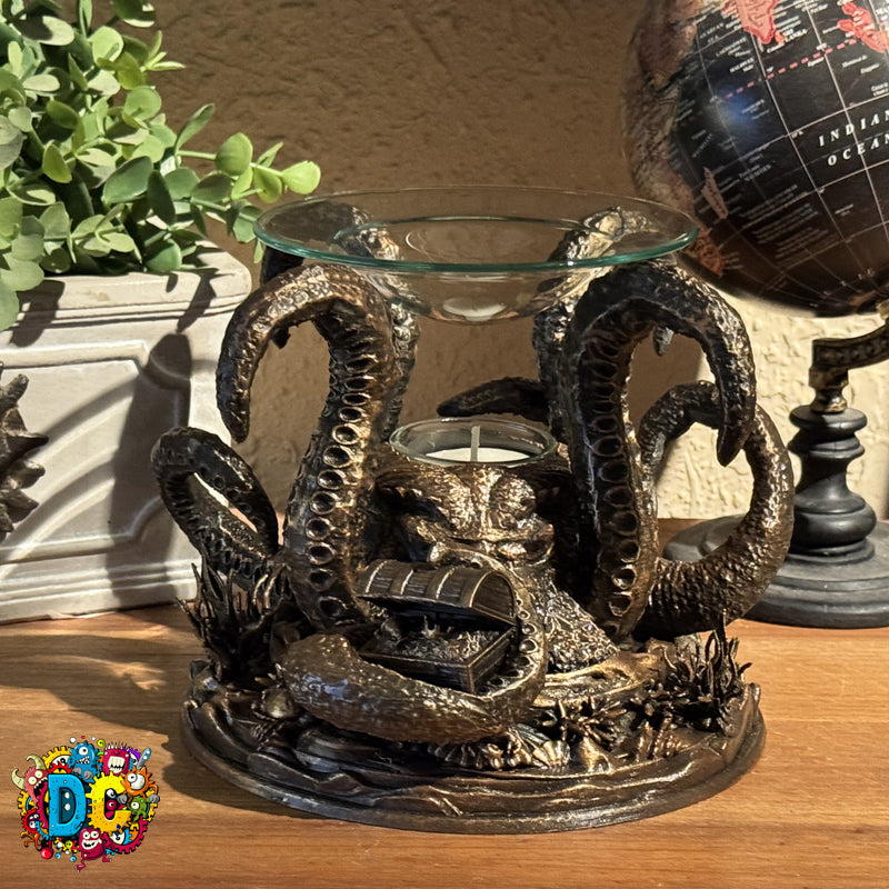 Decorative candle holder shaped like a snake on a wooden surface with a plant and globe in the background.