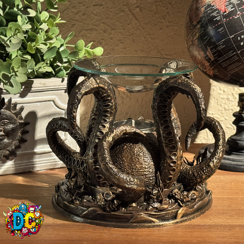 Decorative octopus-shaped candle holder on a wooden surface with plants and a globe in the background.