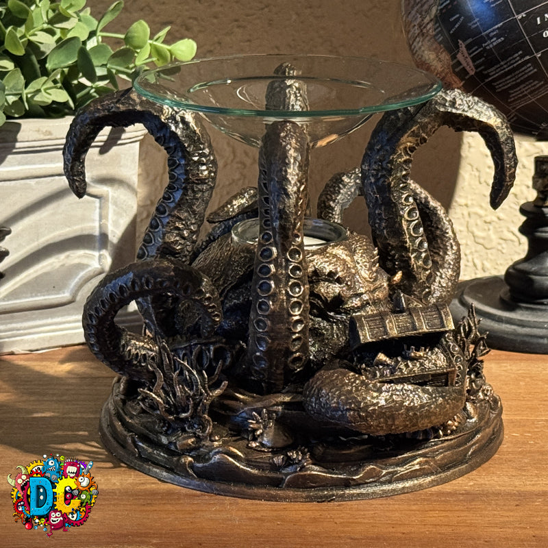 Decorative octopus-shaped candle holder on a wooden surface with a plant in the background.