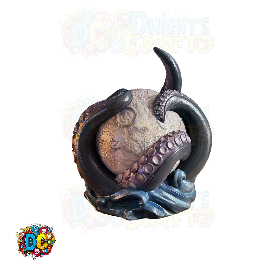 Decorative figurine of a hand holding a sphere with tentacle-like extensions on a white background.