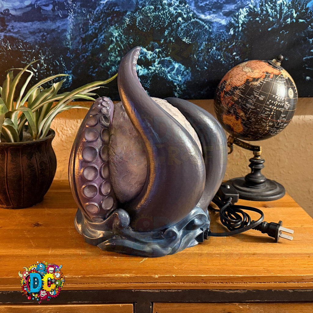 Decorative lamp with unique design on a wooden surface, globe, and plant in the background.