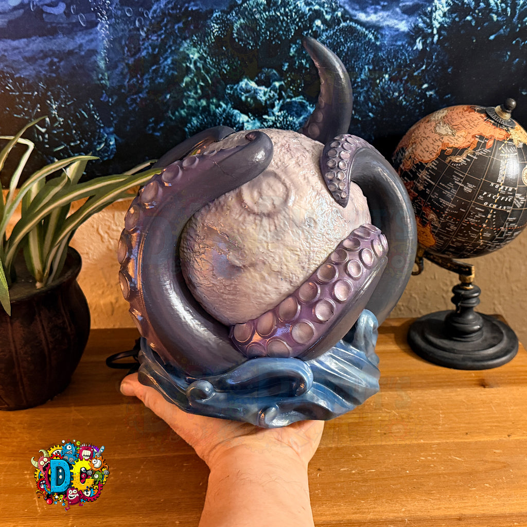 Decorative figurine of an octopus on a moon with a cosmic background