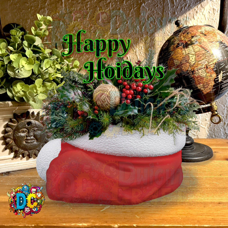Decorative arrangement with a red stocking, greenery, and 'Happy Holidays' text on a wooden surface.